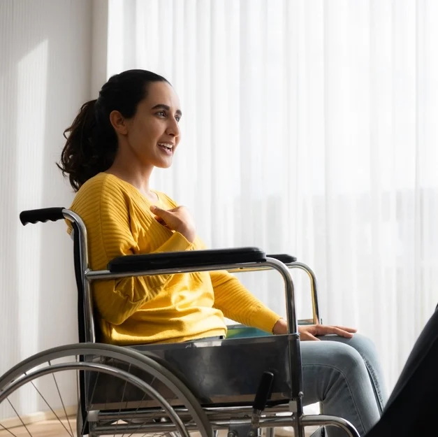 women on wheel chair smiling